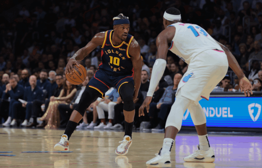 Mar 25, 2025; Miami, Florida, USA; Golden State Warriors forward Jimmy Butler III (10) dribbles the basketball as Miami Heat center Bam Adebayo (13) defends during the first quarter at Kaseya Center. Mandatory Credit: Sam Navarro-Imagn Images