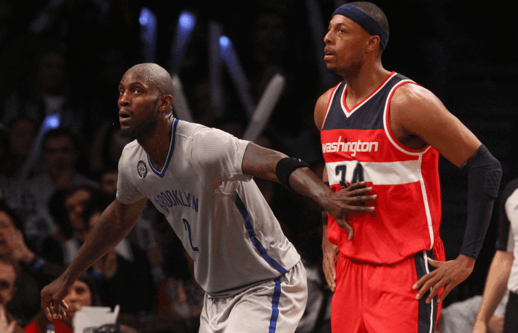 Jan 17, 2015; Brooklyn, NY, USA; Brooklyn Nets power forward Kevin Garnett (2) guards Washington Wizards small forward Paul Pierce (34) during a foul shot during the third quarter at Barclays Center. The Wizards defeated the Nets 99-90. Mandatory Credit: Brad Penner-Imagn Images