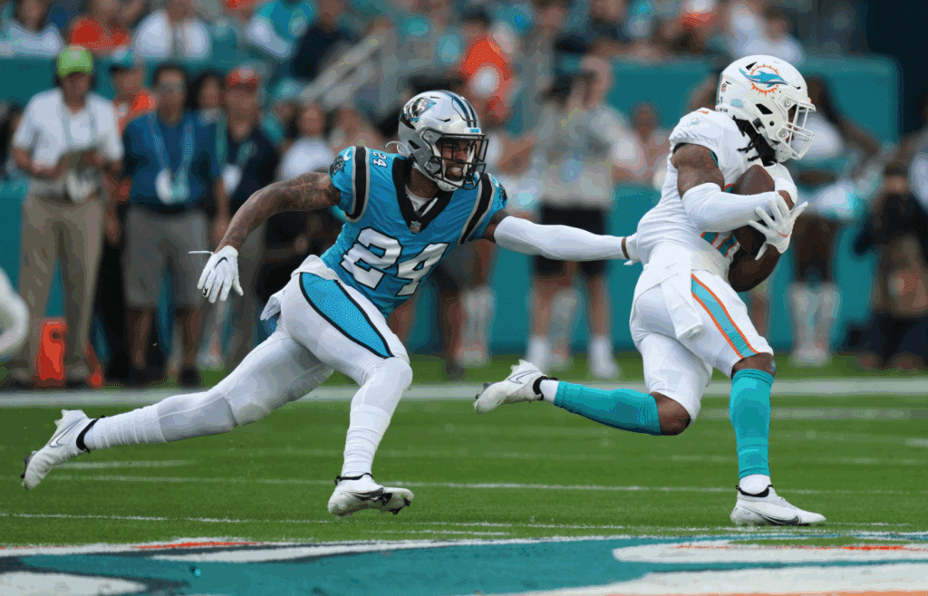 Nov 28, 2021; Miami Gardens, Florida, USA; Miami Dolphins wide receiver Jaylen Waddle (17) runs the ball past Carolina Panthers cornerback A.J. Bouye (24) during the first at Hard Rock Stadium. Mandatory Credit: Jasen Vinlove-Imagn Images