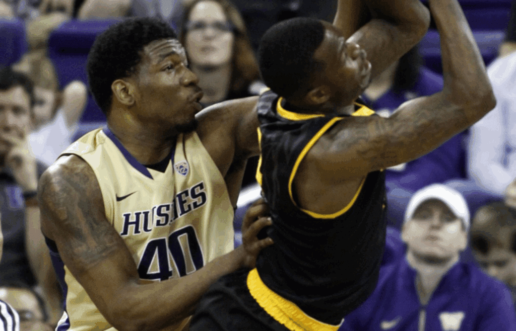 Feb 15, 2015; Seattle, WA, USA; Washington Huskies forward Shawn Kemp, Jr. (40) fouls Arizona State Sun Devils guard Gerry Blakes (4) during the second half at Alaska Airlines Arena. Mandatory Credit: Jennifer Buchanan-Imagn Images