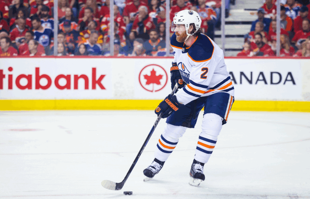 May 26, 2022; Calgary, Alberta, CAN; Edmonton Oilers defenseman Duncan Keith (2) controls the puck against the Calgary Flames during the first period in game five of the second round of the 2022 Stanley Cup Playoffs at Scotiabank Saddledome. Mandatory Credit: Sergei Belski-Imagn Images