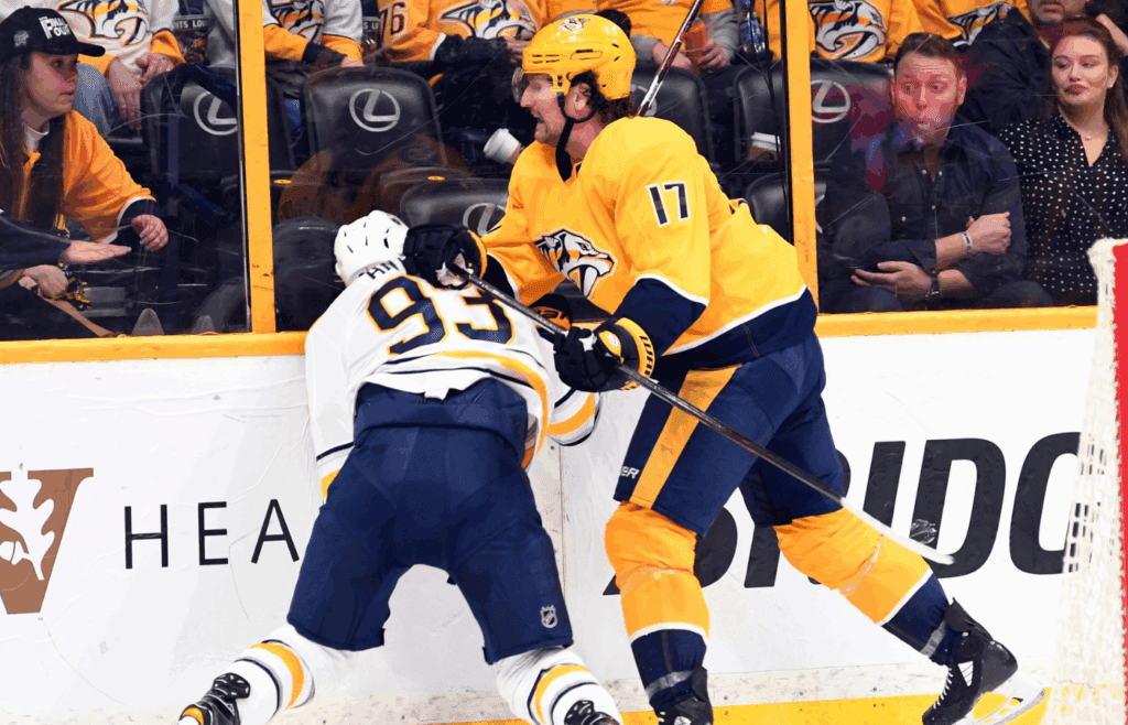 Mar 31, 2018; Nashville, TN, USA; Buffalo Sabres defenseman Victor Antipin (93) is hit into the boards by Nashville Predators left wing Scott Hartnell (17) during the second period at Bridgestone Arena. Antipin left the ice on a stretcher. Mandatory Credit: Christopher Hanewinckel-Imagn Images