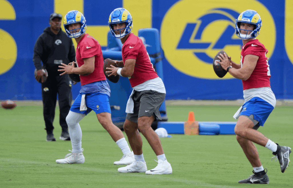 Jun 3, 2025; Woodland Hills, CA, USA; Los Angeles Rams quarterbacks Matthew Stafford (left), Jimmy Garoppolo (center) and Stetson Bennett throw the ball during organized team activities at Rams Practice Facility. Mandatory Credit: Kirby Lee-Imagn Images
