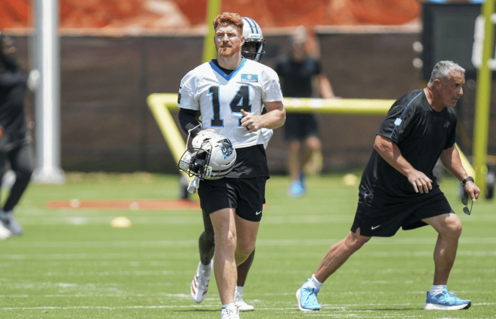 Jun 11, 2025; Charlotte, NC, USA; Carolina Panthers quarterback Andy Dalton (14) trots back to the huddle during minicamp at Bank of America Stadium. Mandatory Credit: Jim Dedmon-Imagn Images