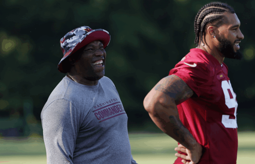Jun 15, 2022; Ashburn, Virginia, USA; Washington Commanders defensive end Montez Sweat (90) jokes with special consultant and NFL Hall of Fame member Warren Sapp (R) on day two of minicamp at The Park. Mandatory Credit: Geoff Burke-Imagn Images