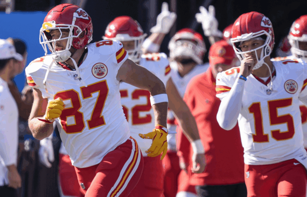 Kansas City Chiefs tight end Travis Kelce (87) and quarterback Patrick Mahomes (15) lead their team onto the field against the Carolina Panthers