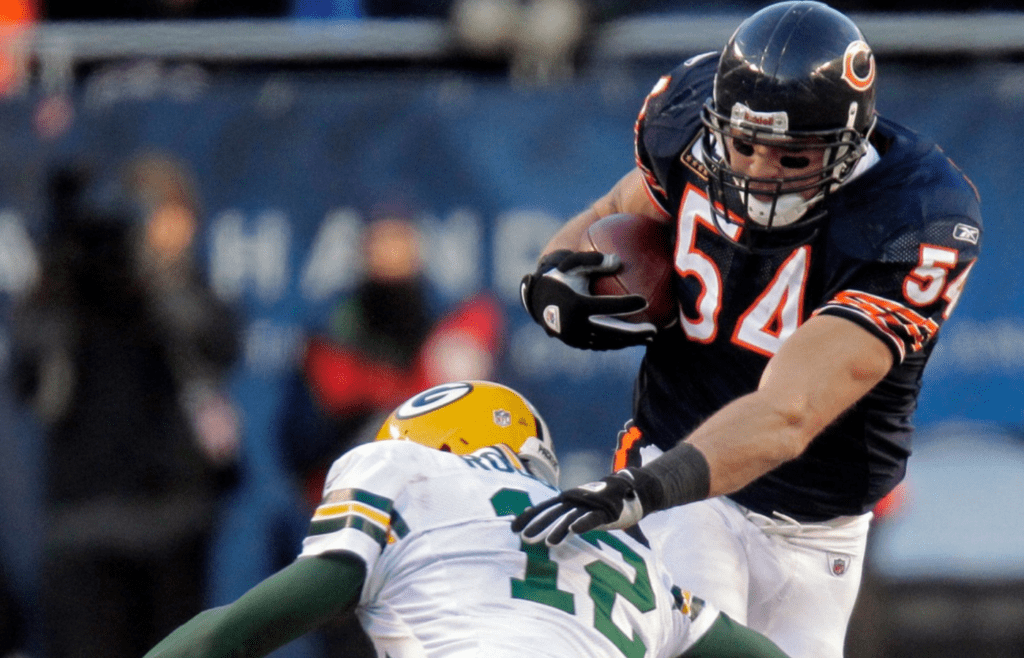 Chicago Bears linebacker Brian Urlacher is tackled by Green Bay Packers quarterback Aaron Rodgers after picking off a pass he threw during the third quarter of their NFC Championship game Sunday, January 23, 2011 at Soldier Field in Chicago, Ill. Mjs Packers24 19 Of Hoffman Jpg Packers24