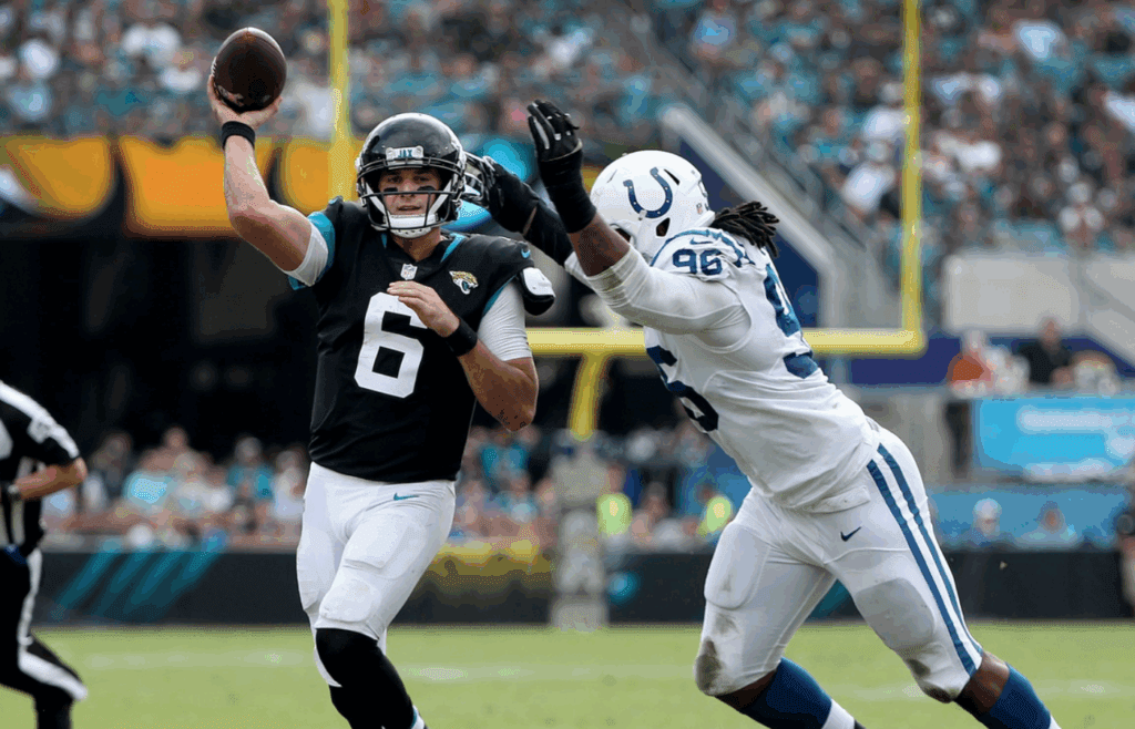 Jacksonville Jaguars quarterback Cody Kessler (6) gets the ball away before getting hit by Indianapolis Colts defensive tackle Denico Autry (96) in the second quarter of their game at TIAA Bank Field on Thursday, Dec. 2, 2018.