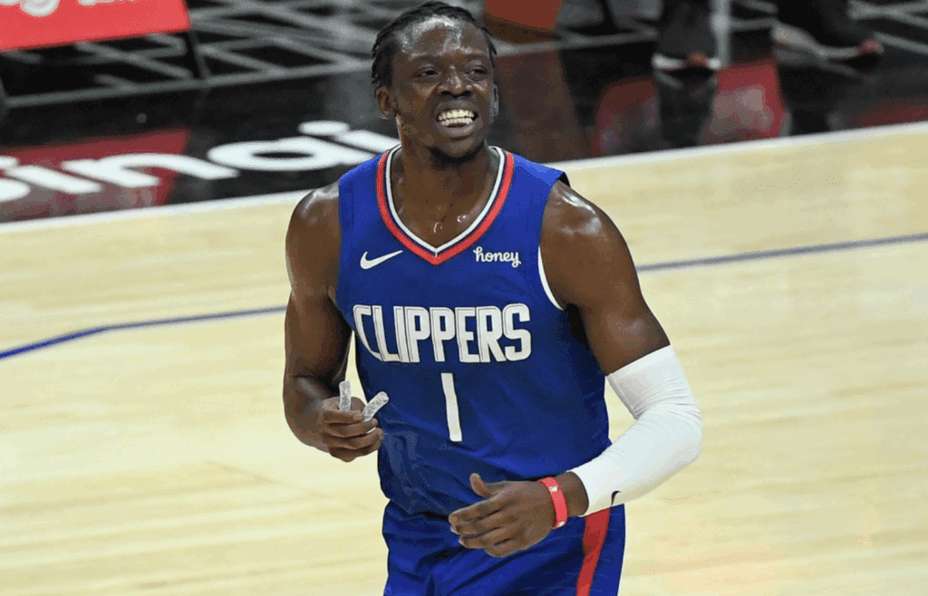 Dec 30, 2020; Los Angeles, California, USA; LA Clippers guard Reggie Jackson (1) is all smiles after scoring a basket in the second quarter against the Portland Trail Blazers at Staples Center. Mandatory Credit: Robert Hanashiro-Imagn Images