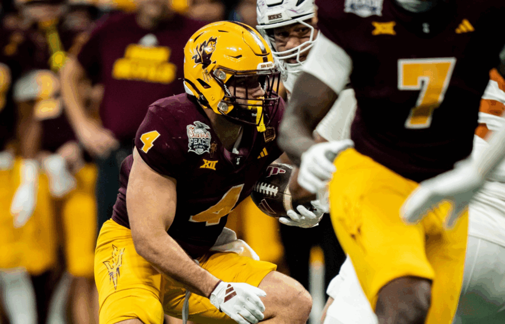 Arizona State Sun Devils running back Cam Skattebo (4) looks for a route through the Texas defense in the first overtime period as the Texas Longhorns play the Arizona State Sun Devils in the Peach Bowl College Football Playoff quarterfinal at Mercedes-Benz Stadium in Atlanta, Georgia, Jan. 1, 2025.