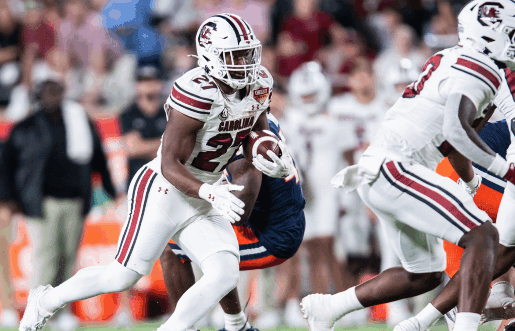 Dec 31, 2024; Orlando, FL, USA; South Carolina Gamecocks running back Oscar Adaway III (27) runs the ball against the Illinois Fighting Illini in the. fourth quarter at Camping World Stadium. Mandatory Credit: Jeremy Reper-Imagn Images