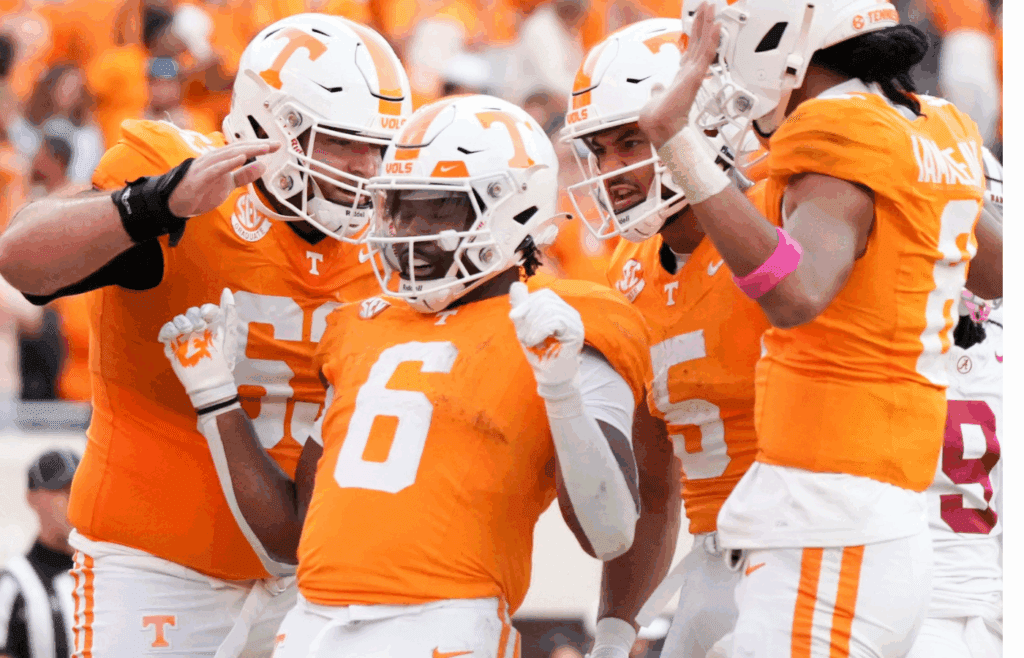 Tennessee offensive lineman Cooper Mays (63), wide receiver Bru McCoy (5), and quarterback Nico Iamaleava (8) surround running back Dylan Sampson (6) in celebration after Sampson's touchdown during an NCAA college football game against Alabama on Saturday, Oct. 19, 2024, in Knoxville. Tenn.