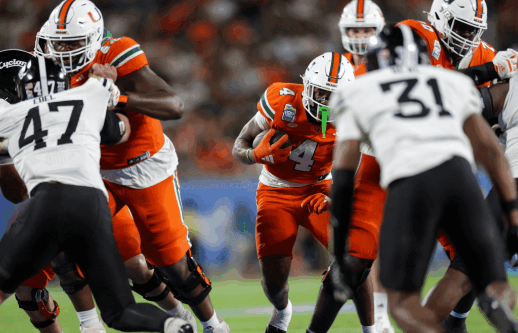 Dec 28, 2024; Orlando, FL, USA; Miami Hurricanes running back Mark Fletcher Jr. (4) runs with the ball against the Iowa State Cyclones in the fourth quarter during the Pop Tarts bowl at Camping World Stadium. Mandatory Credit: Nathan Ray Seebeck-Imagn Images