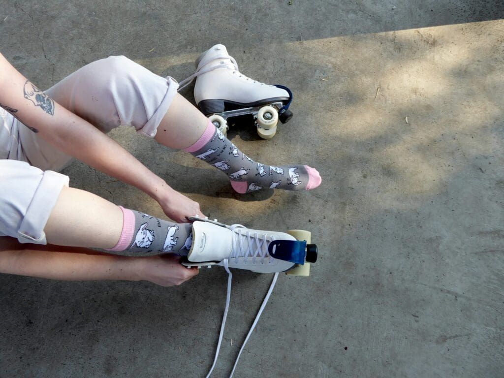 A person sitting on a skateboard on the ground