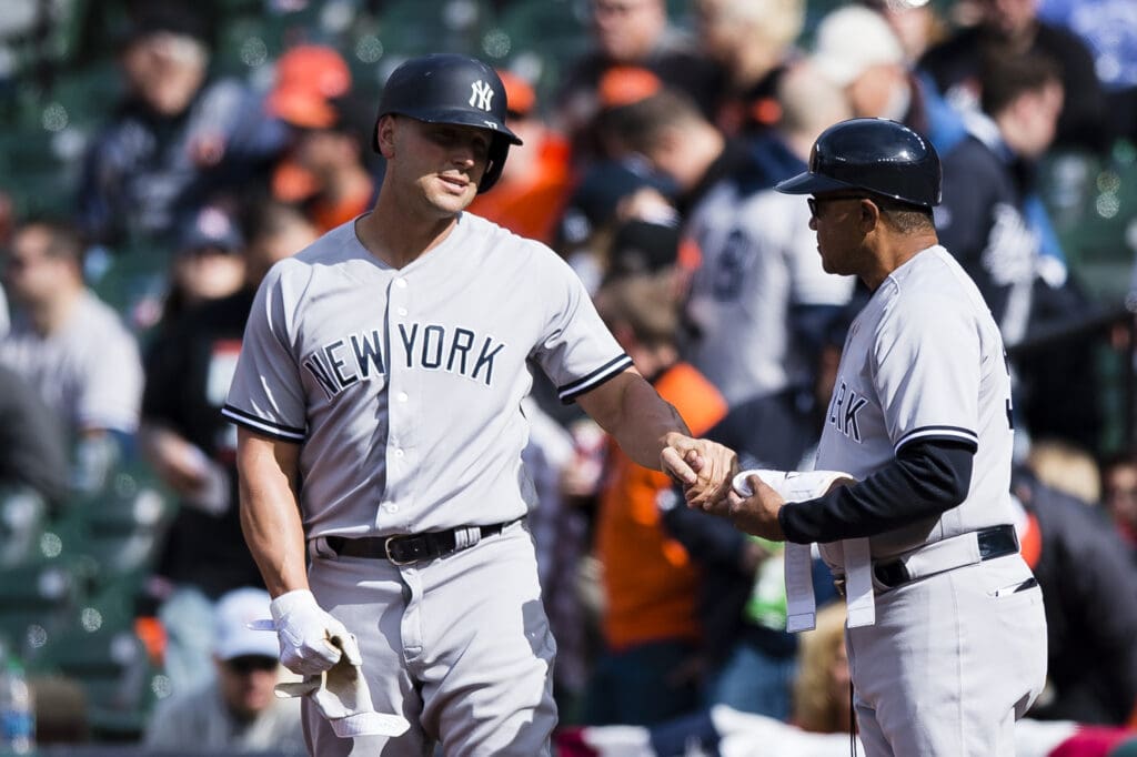 Apr 8, 2017; Baltimore, MD, USA; New York Yankees left fielder Matt Holliday (17) celebrates with New York Yankees first base coach Tony Pena (56) after hitting a single for his 2,000th career hit in the first inning against the Baltimore Orioles at Oriole Park at Camden Yards. Mandatory Credit: Patrick McDermott-USA TODAY Sports