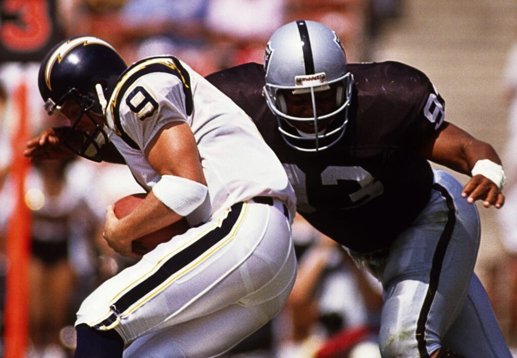 Sep 10, 1989; Los Angeles, CA, USA; FILE PHOTO; Los Angeles Raiders linebacker Greg Townsend (93) in action against San Diego Chargers quarterback Jim McMahon (9) at Los Angeles Memorial Coliseum. Mandatory Credit: Peter Brouillet-USA TODAY NETWORK