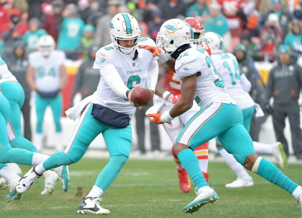 Dec 24, 2017; Kansas City, MO, USA; Miami Dolphins quarterback Jay Cutler (6) hands off to running back Kenyan Drake (32) during the first half against the Kansas City Chiefs  at Arrowhead Stadium. Mandatory Credit: Denny Medley-USA TODAY Sports