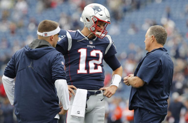 Sep 9, 2018; Foxborough, MA, USA; New England Patriots quarterback Tom Brady (12) talks with head coach Bill Belichick and offensive coordinator Josh McDaniels during warm ups before the start of the game against the Houston Texans at Gillette Stadium. Mandatory Credit: David Butler II-USA TODAY Sports