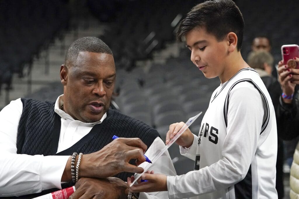 Dec 28, 2019; San Antonio, Texas, USA; Detroit Pistons radio analyst and former NBA player Rick Mahorn signs an autograph for San Antonio Spurs fan before the game at the AT&T Center. Mandatory Credit: Scott Wachter-USA TODAY Sports