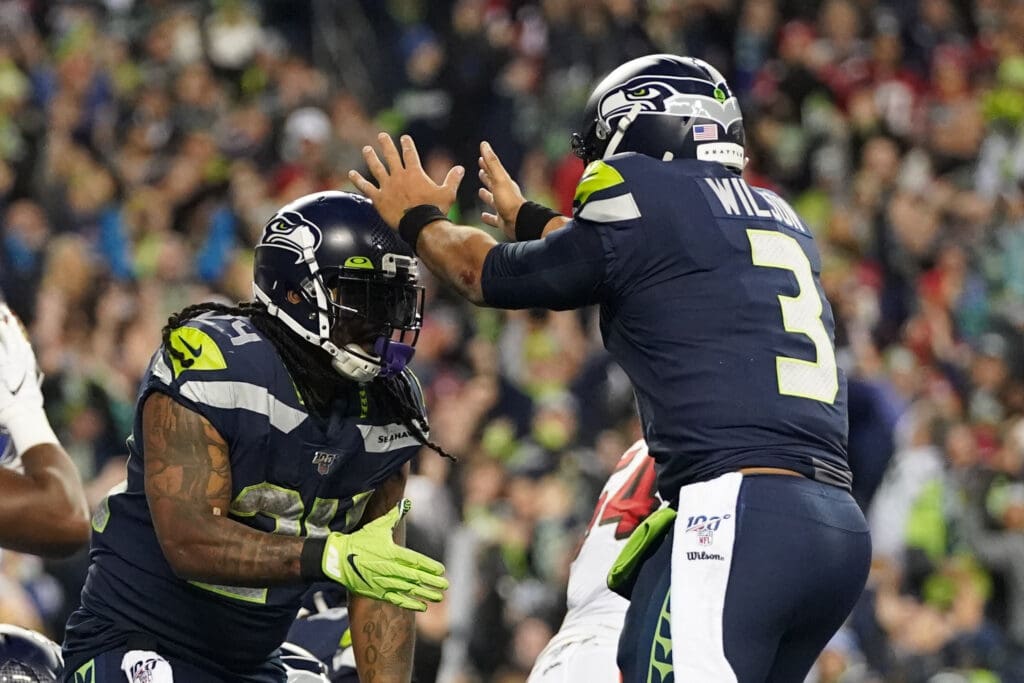 December 29, 2019; Seattle, Washington, USA; Seattle Seahawks running back Marshawn Lynch (24) is congratulated by quarterback Russell Wilson (3) for scoring a touchdown during the third quarter against the San Francisco 49ers at CenturyLink Field. Mandatory Credit: Kyle Terada-USA TODAY Sports