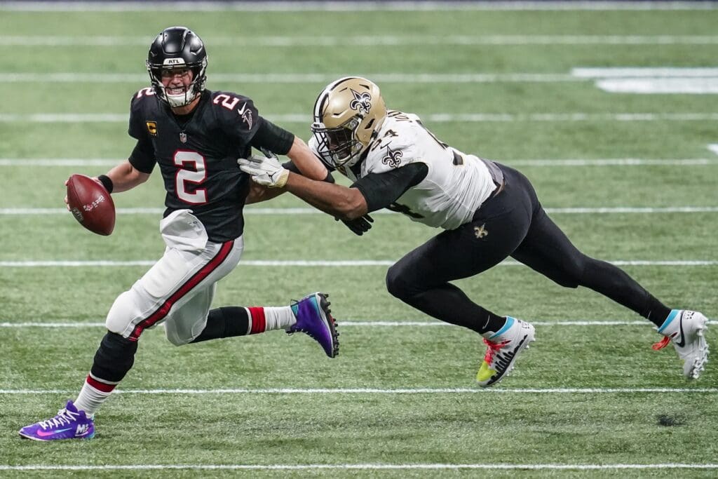 Dec 6, 2020; Atlanta, Georgia, USA; Atlanta Falcons quarterback Matt Ryan (2) runs to escape a tackle by New Orleans Saints defensive end Cameron Jordan (94) during the second half at Mercedes-Benz Stadium. Mandatory Credit: Dale Zanine-USA TODAY Sports