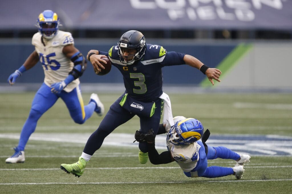 Jan 9, 2021; Seattle, Washington, USA; Seattle Seahawks quarterback Russell Wilson (3) runs the ball while Los Angeles Rams cornerback Troy Hill (22) defends during the second quarter at Lumen Field. Mandatory Credit: Joe Nicholson-USA TODAY Sports