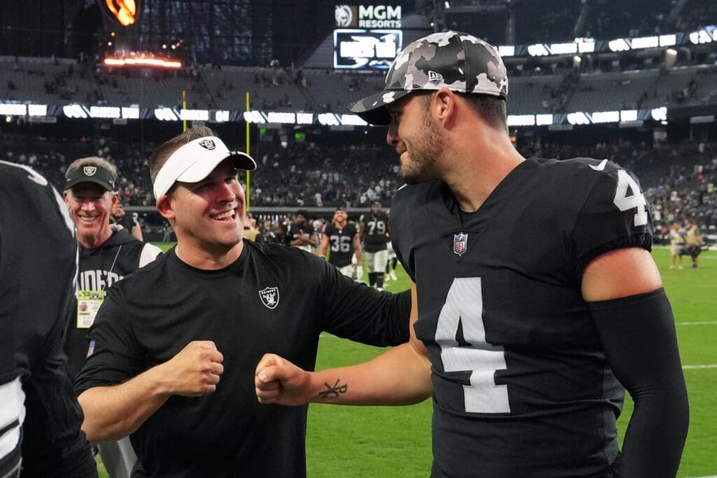 Aug 26, 2022; Paradise, Nevada, USA; Las Vegas Raiders coach Josh McDaniels (left) and quarterback Derek Carr (4) celebrate after the game against the New England Patriots at Allegiant Stadium. Mandatory Credit: Kirby Lee-USA TODAY Sports