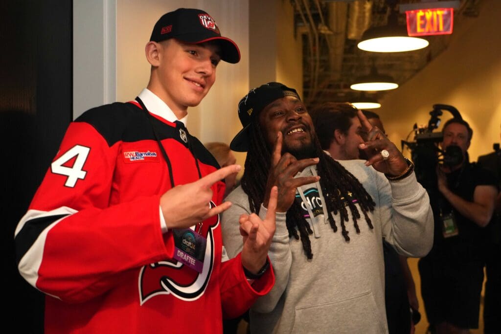 Jun 28, 2024; Las Vegas, Nevada, USA; Former NFL player Marshawn Lynch poses for a photo with New Jersey Devils draft pick Anton Silayev during the 2024 NHL Draft at The Sphere. Mandatory Credit: Joe Camporeale-USA TODAY Sports