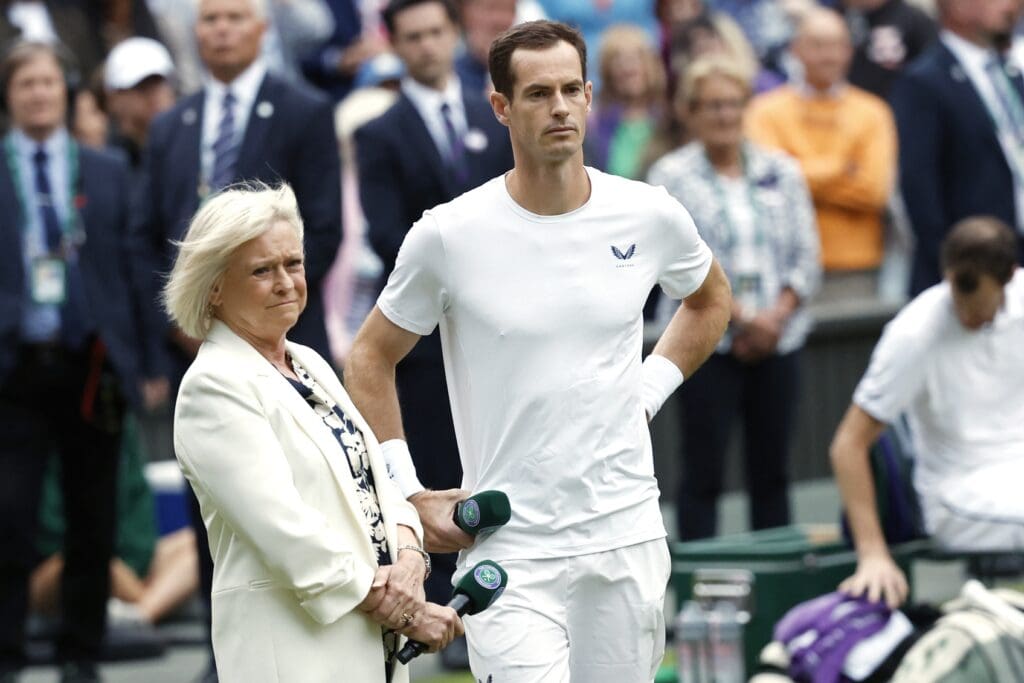 Jul 4, 2024; London, United Kingdom; Andy Murray (GBR) watches a tribute video during a ceremony honoring his Wimbledon career alongside former BBC presenter Sue Barker (L) after participating in a gentlemen's doubles match with brother Jamie Murray (not pictured)(GBR) against Rinky Hijikata (AUS) and John Peers (AUS)(both not pictured) on day four of The Championships Wimbledon 2024 at All England Lawn Tennis and Croquet Club. Mandatory Credit: Geoff Burke-USA TODAY Sports