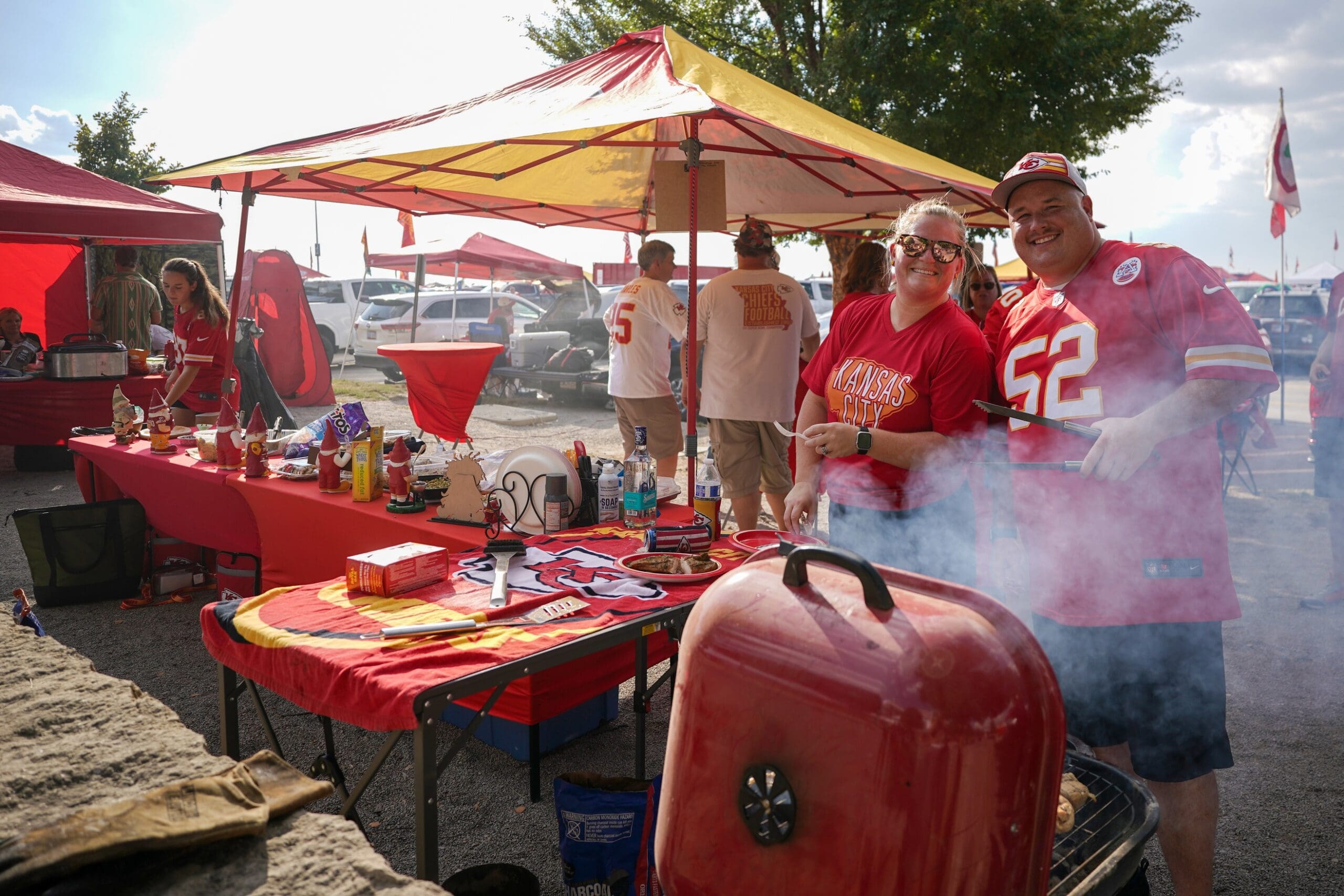 Sep 5, 2024; Kansas City, Missouri, USA; Kansas City Chiefs fans tailgate in the parking lots prior to a game against the Baltimore Ravens at GEHA Field at Arrowhead Stadium. Mandatory Credit: Denny Medley-Imagn Images
