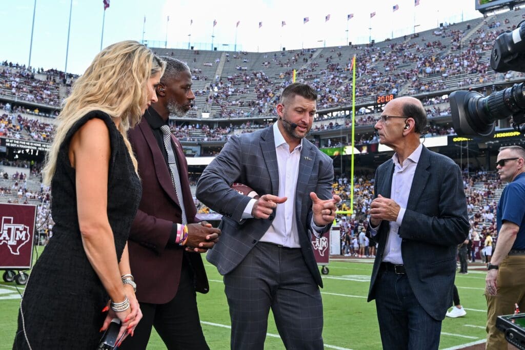 Oct 5, 2024; College Station, Texas, USA; SEC Nation host Laura Rutledge, analyst Roman Harper, analyst Tim Tebow and analyst Paul Finebaum speak prior to the game between the Texas A&M Aggies and the Missouri Tigers at Kyle Field. Mandatory Credit: Maria Lysaker-Imagn Images.