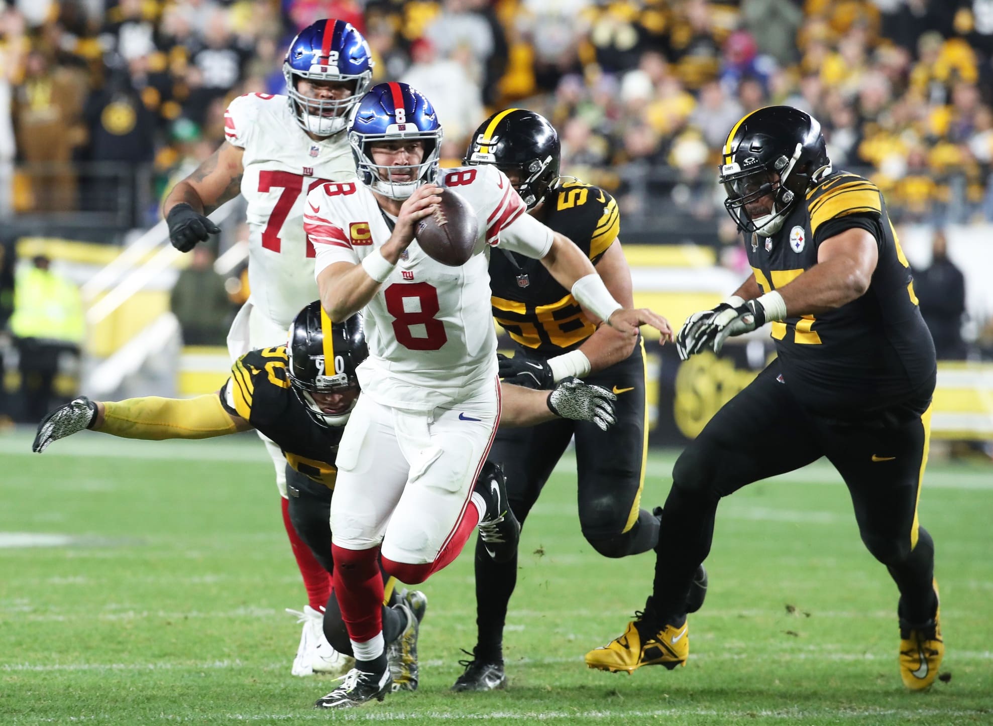 Oct 28, 2024; Pittsburgh, Pennsylvania, USA; New York Giants quarterback Daniel Jones (8) runs the ball against the Pittsburgh Steelers during the fourth quarter at Acrisure Stadium. Mandatory Credit: Charles LeClaire-Imagn Images
