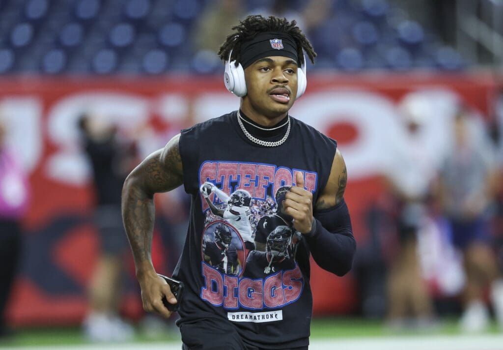 Nov 10, 2024; Houston, Texas, USA; Houston Texans wide receiver Tank Dell (3) wears a shirt with wide receiver Stefon Diggs (1) before the game against the Detroit Lions at NRG Stadium. Mandatory Credit: Troy Taormina-Imagn Images