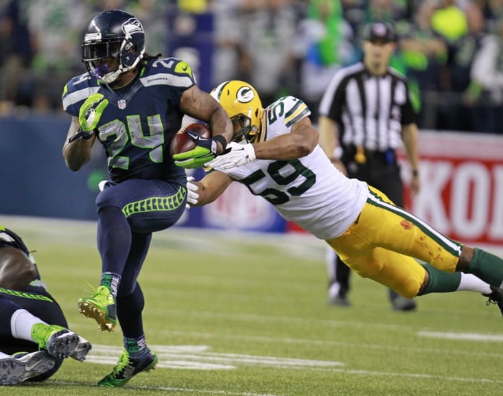 Seattle Seahawks running back Marshawn Lynch (24) runs for a 1st down past Green Bay Packers inside linebacker Brad Jones (59) during the 4th quarter of the Green Bay Packers game against the Seattle Seahawks Thursday, September 4, 2014 at CenturyLink Field in Seattle, Wash.