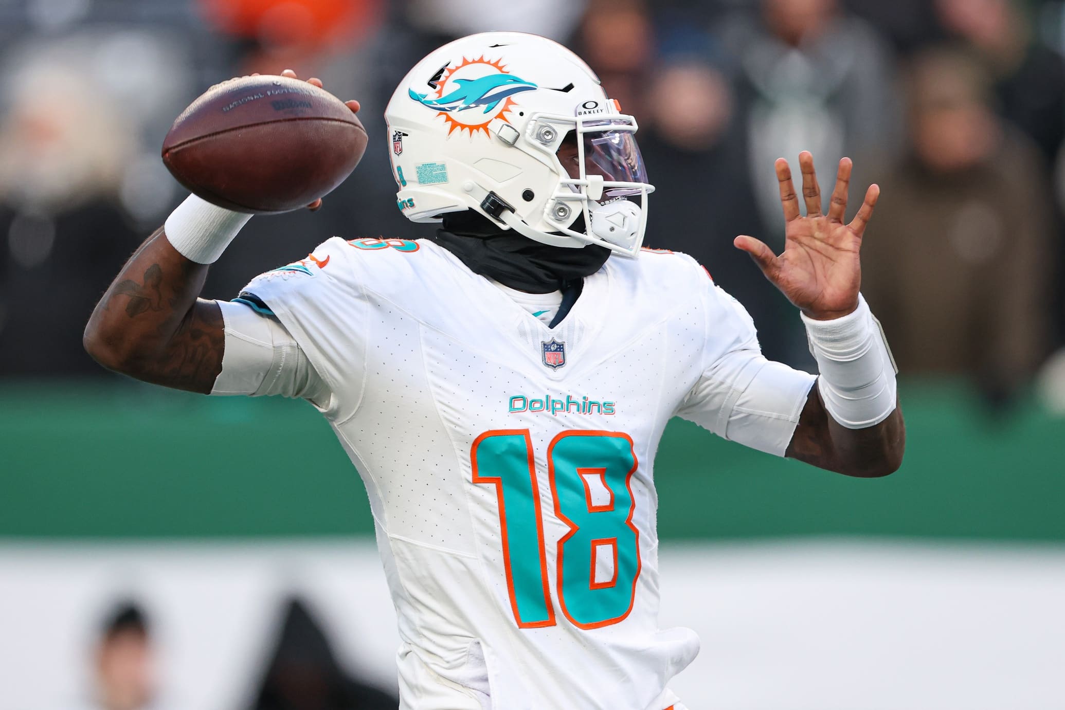Jan 5, 2025; East Rutherford, New Jersey, USA; Miami Dolphins quarterback Tyler Huntley (18) warms up before the game against the New York Jets at MetLife Stadium. Mandatory Credit: Vincent Carchietta-Imagn Images