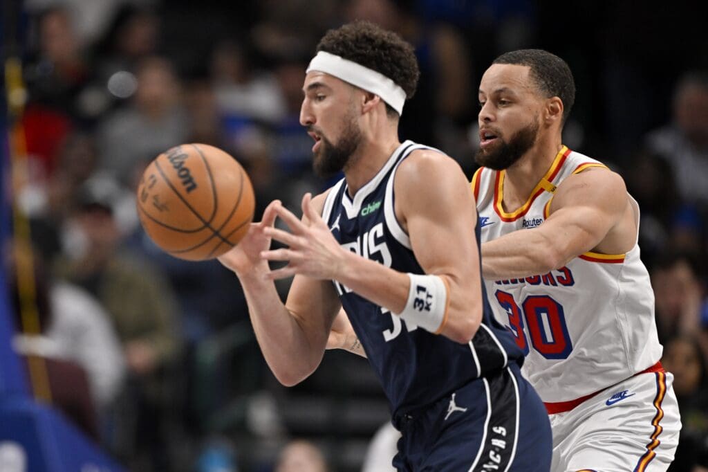 Feb 12, 2025; Dallas, Texas, USA; Dallas Mavericks guard Klay Thompson (31) moves the ball past Golden State Warriors guard Stephen Curry (30) during the second quarter at the American Airlines Center. Mandatory Credit: Jerome Miron-Imagn Images