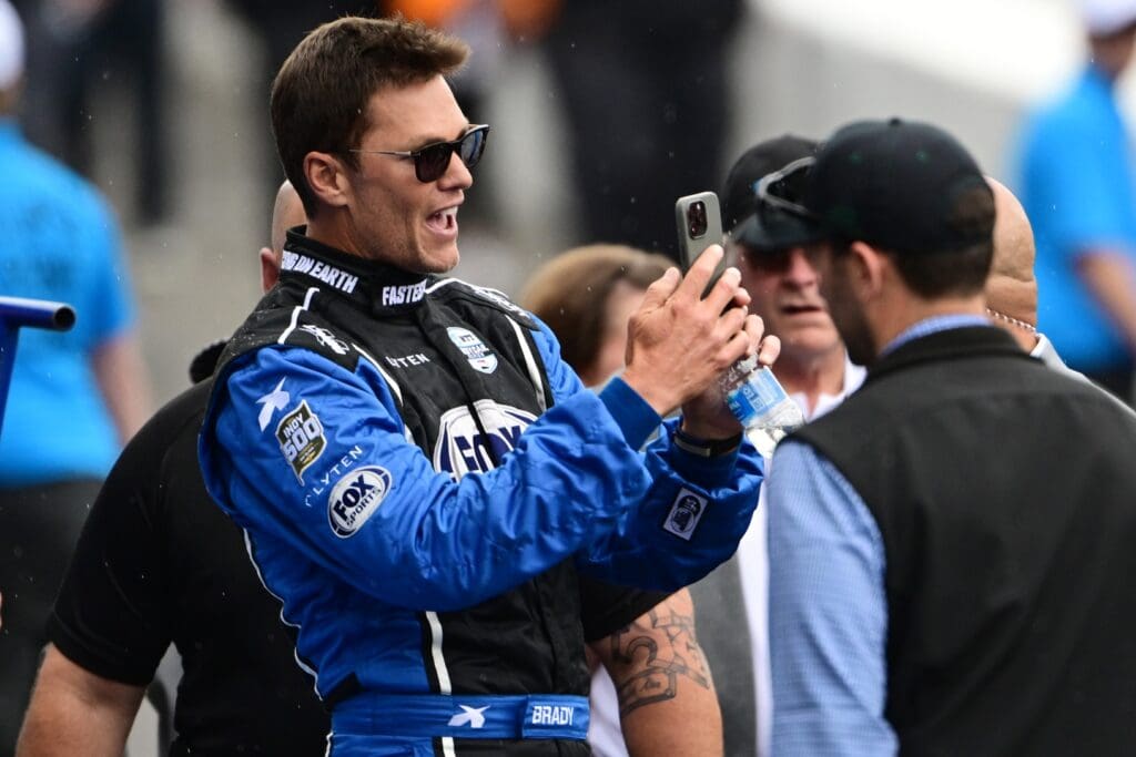May 25, 2025; Indianapolis, Indiana, USA; Tom Brady looks on before the 109th Running of the Indianapolis 500 at Indianapolis Motor Speedway. Mandatory Credit: Marc Lebryk-Imagn Images