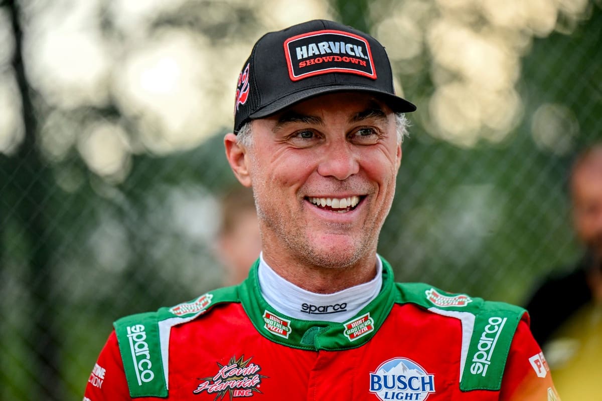 Former NASCAR Cup Series champion Kevin Harvick smiles during an autograph session before the 13th annual Masters of the Pros 200 race on Wednesday, July 16, 2025, at the Owosso Speedway. Harvick and his 13-year-old son Keelan competed against each other in the race later in the night.