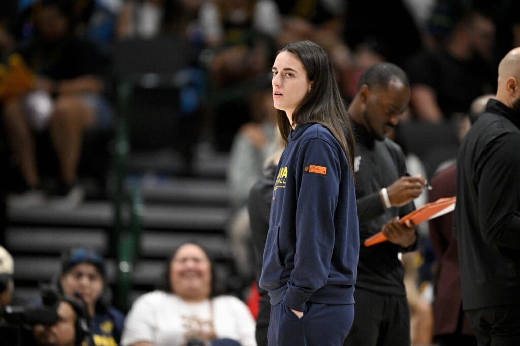 Aug 1, 2025; Dallas, Texas, USA; Indiana Fever guard Caitlin Clark (22) looks on from the team bench during the first half against the Dallas Wings at the American Airlines Center. Mandatory Credit: Jerome Miron-Imagn Images