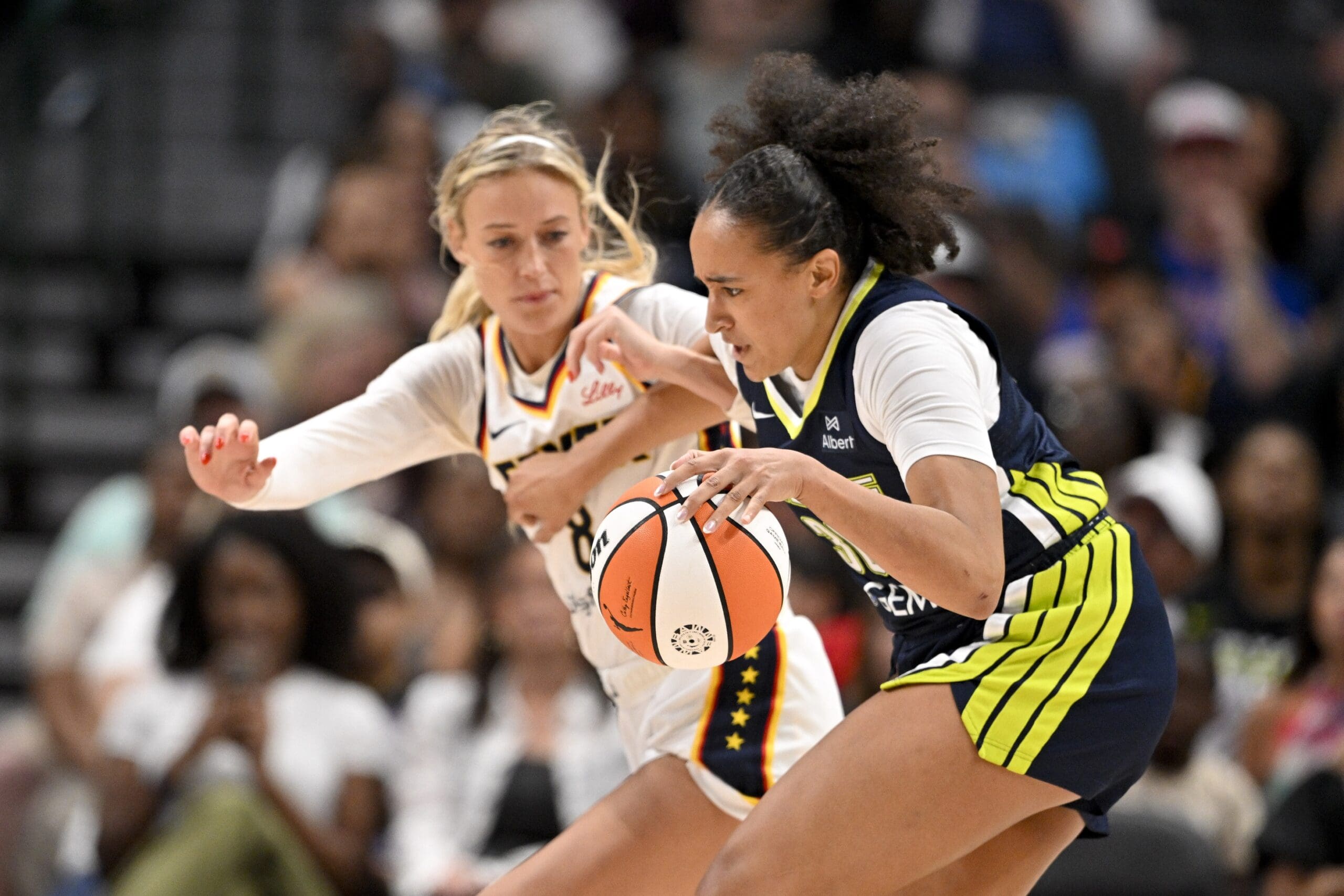 Aug 1, 2025; Dallas, Texas, USA; Dallas Wings guard Haley Jones (30) drives to the basket past Indiana Fever guard Sophie Cunningham (8) during the second half at the American Airlines Center. Mandatory Credit: Jerome Miron-Imagn Images