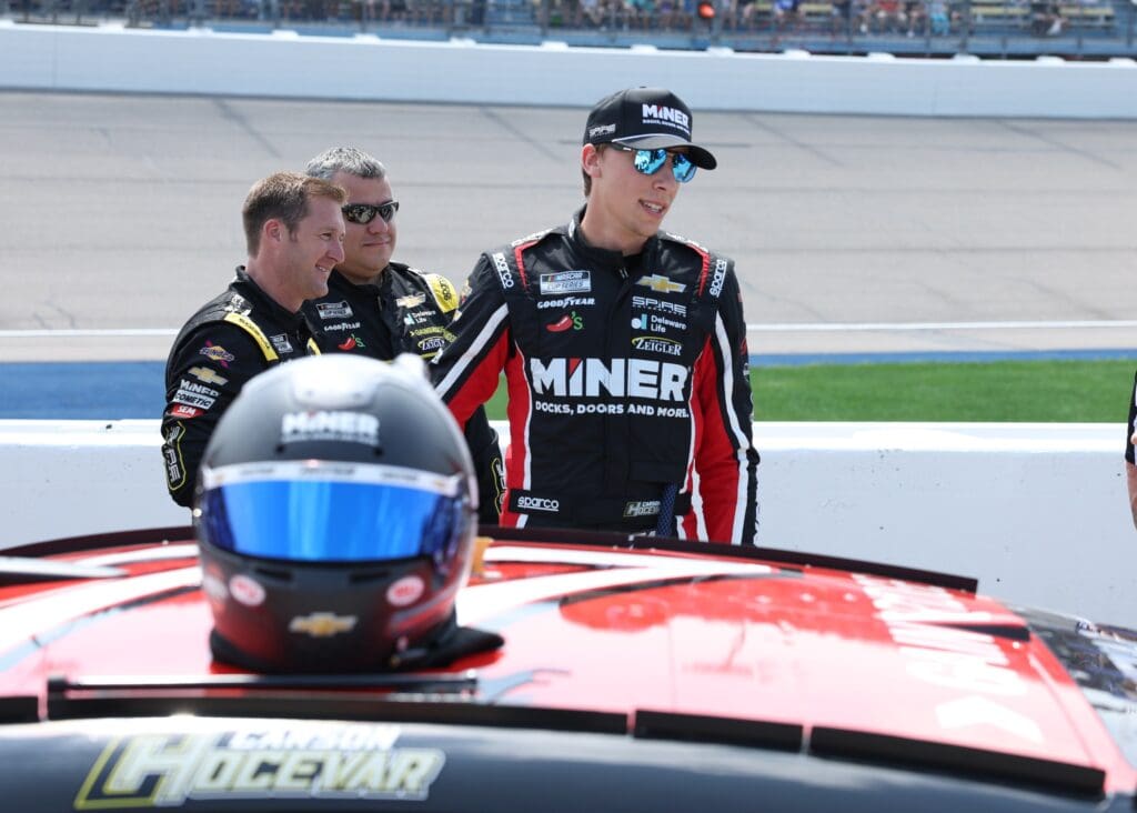Aug 3, 2025; Newton, Iowa, USA; NASCAR Cup Series driver Carson Hocevar (77) waits for the start of the Iowa Corn 350 at the Iowa Speedway. Mandatory Credit: Reese Strickland-Imagn Images