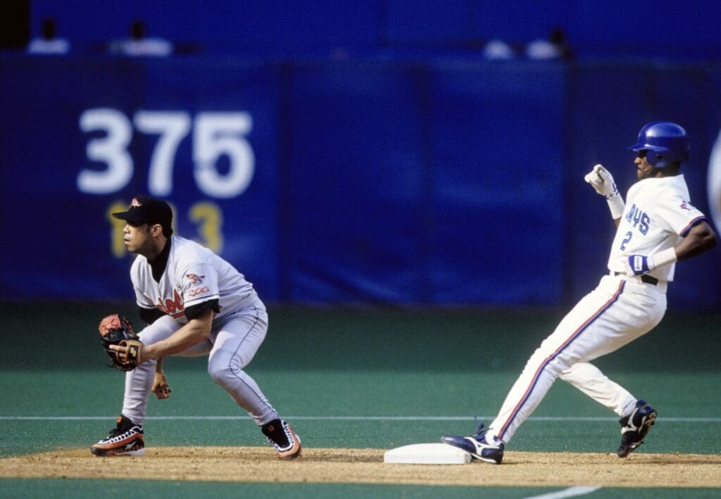 Jun 21, 1997; Toronto, ON, CANADA; FILE PHOTO; Toronto Blue Jays  outfielder Otis Nixon (2) runs to 2nd base as Baltimore Orioles infielder Roberto Alomar (left) waits for the ball at the Skydome. Mandatory Credit: USA TODAY Sports
