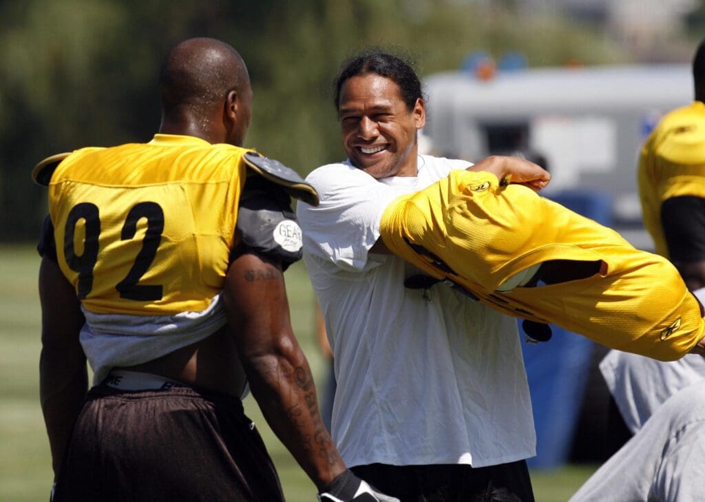 July 31, 2011; Latrobe,PA, USA: Pittsburgh Steelers linebacker James Harrison (92) laughs with safety Troy Polamalu (right) on the field at training camp held at St. Vincent College. Mandatory Credit: Charles LeClaire-USPRESSWIRE