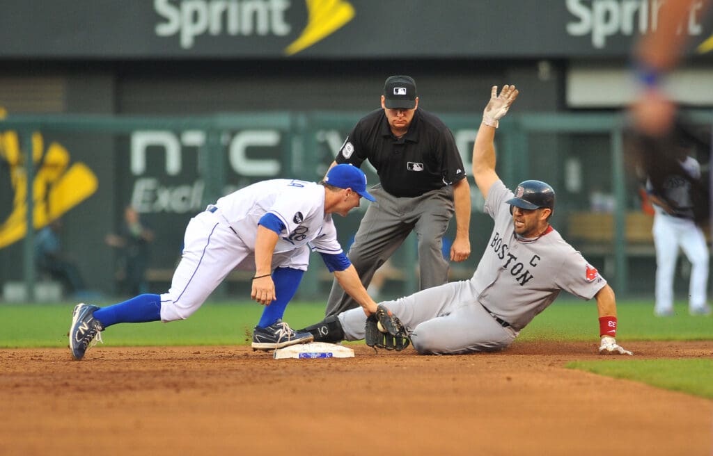 August 18, 2011; Kansas City, MO, USA; Kansas City Royals second baseman Johnny Giavotella (left) makes the tag on Boston Red Sox catcher Jason Varitek (33) at second base in the second inning at Kauffman Stadium. Mandatory Credit: Denny Medley-USA TODAY Sports