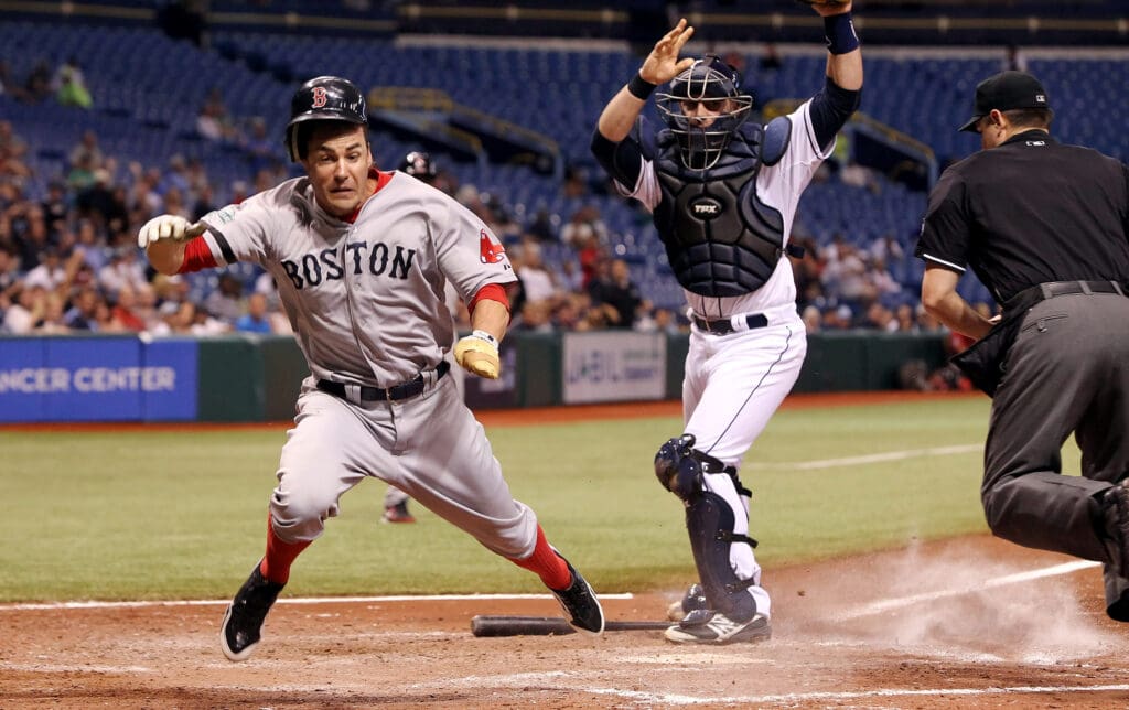 September 18, 2012; St. Petersburg, FL, USA; Boston Red Sox left fielder Scott Podsednik (26) is tagged out by Tampa Bay Rays catcher Chris Gimenez (16) in the sixth inning at Tropicana Field. Mandatory Credit: Kim Klement-USA TODAY Sports