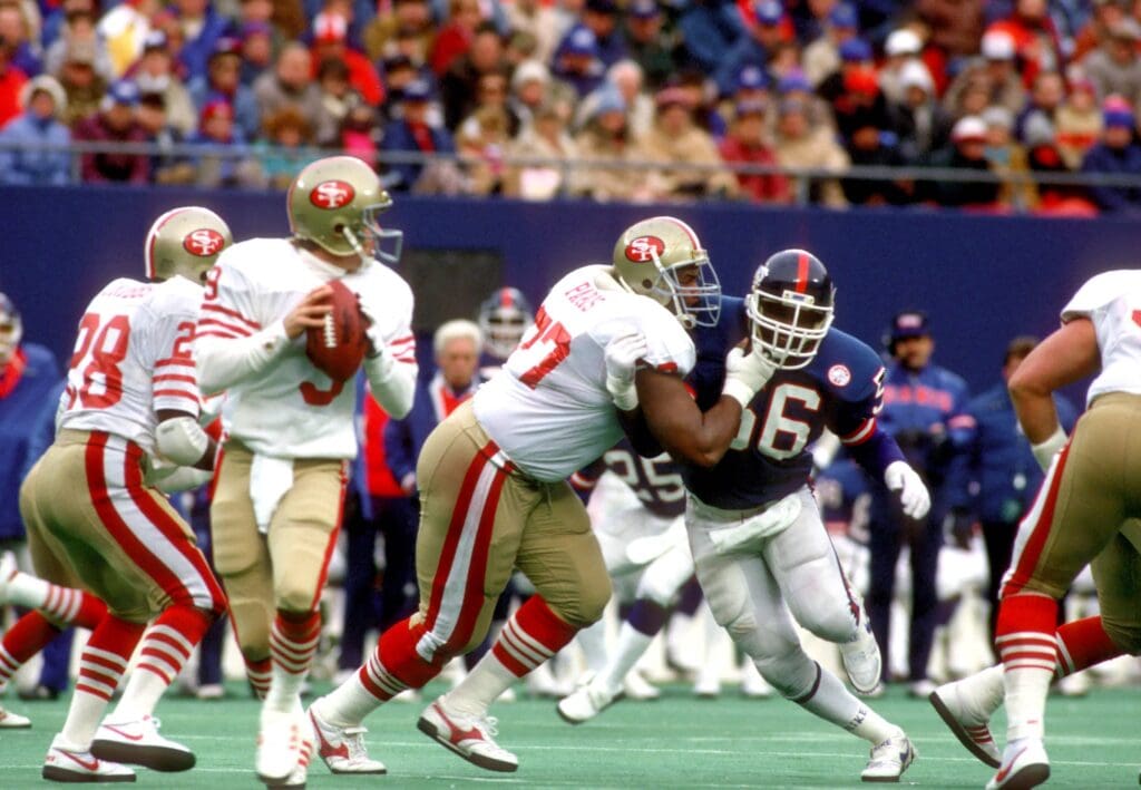 Jan 4, 1987; E. Rutherford, NJ, USA; FILE PHOTO; New York Giants linebacker (56) LAWRENCE TAYLOR is blocked by San Francisco 49ers tackle (77) BUBBA PARIS as he rushes quarterback (9 )JEFF KEMP at Giants Stadium during the 1986 NFC Divisional Playoff Game. The Giants defeated the 49ers 49-3. Mandatory Credit: Tony Tomsic-USA TODAY NETWORK