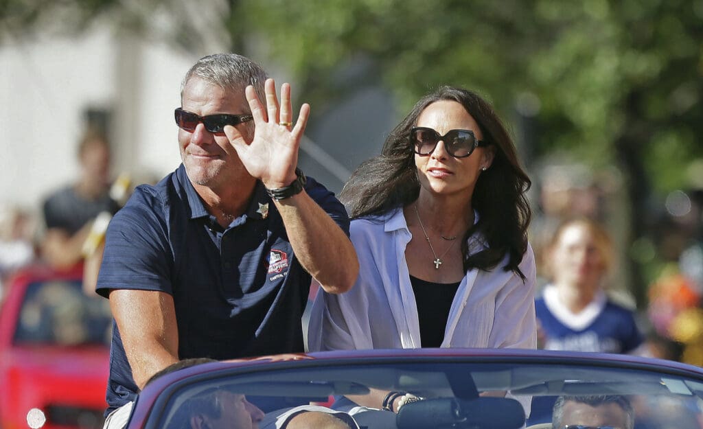 Aug 6, 2016; Canton, OH, USA; Hall of Fame inductee Brett Favre and his wife Deanna Favre wave to the crowd along the parade route during the Canton Repository Grand Parade as part of the NFL Pro Football Hall of Fame Enshrinement Festival. Mandatory Credit: Rick Wood/Milwaukee Journal Sentinel via USA TODAY Network