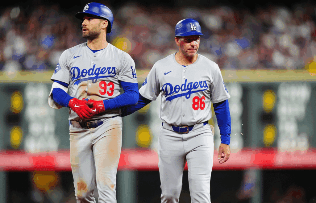 Sep 28, 2024; Denver, Colorado, USA; Los Angeles Dodgers center fielder Kevin Kiermaier (93) walks off with first base coach Clayton McCullough (86) following a injury in the fourth inning against the Colorado Rockies at Coors Field. Mandatory Credit: Ron Chenoy-Imagn Images