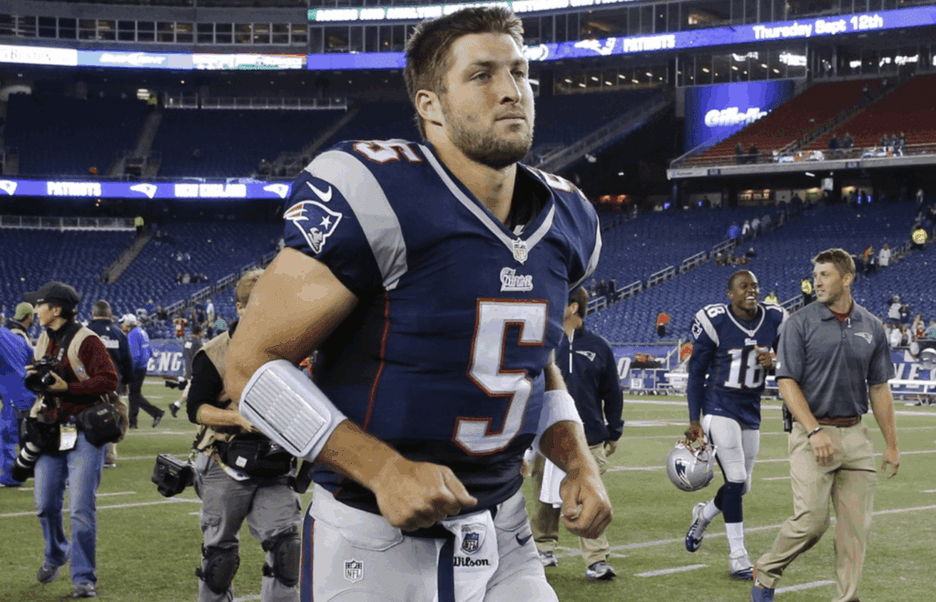 Aug 29, 2013; Foxborough, MA, USA; New England Patriots quarterback Tim Tebow (5) exits the field after the game against the New York Giants at Gillette Stadium. The Patriots defeated the Giants 28-20. Mandatory Credit: David Butler II-Imagn Images
