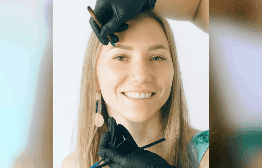 Expert performing eyebrow microblading on woman
